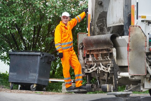 Crew assessing garden waste before removal